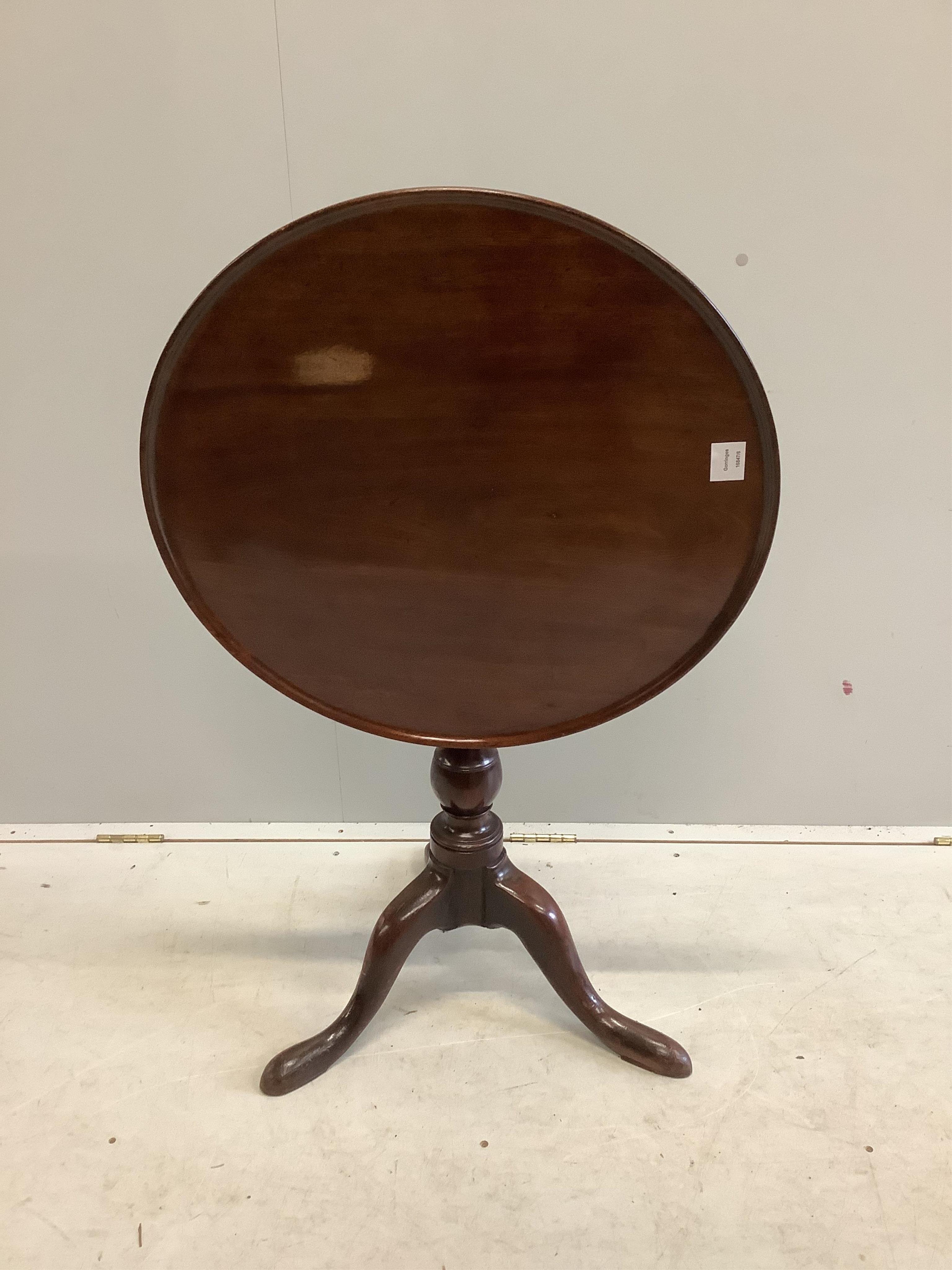 A George III circular mahogany tilt top tripod tea table, diameter 63cm, height 69cm. Condition - fair